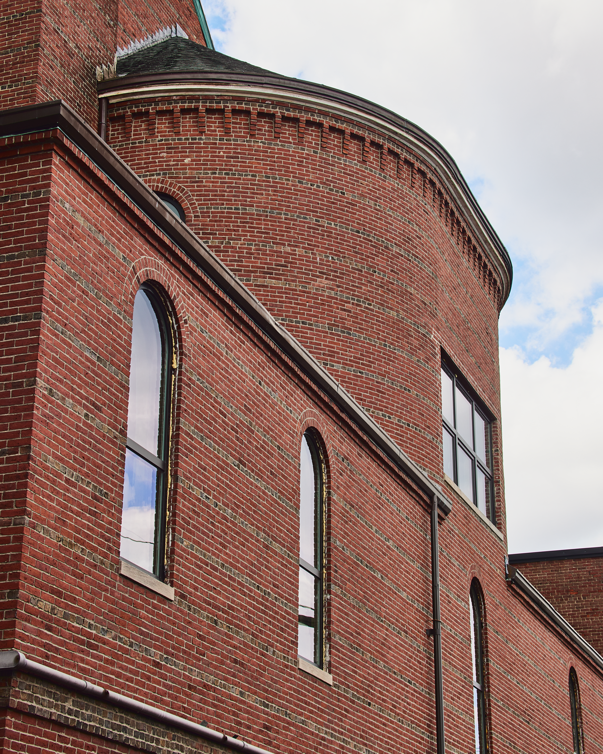 Curved brick apse with arched windows on the converted church building at 163 Chestnut Street in Chelsea, Massachusetts